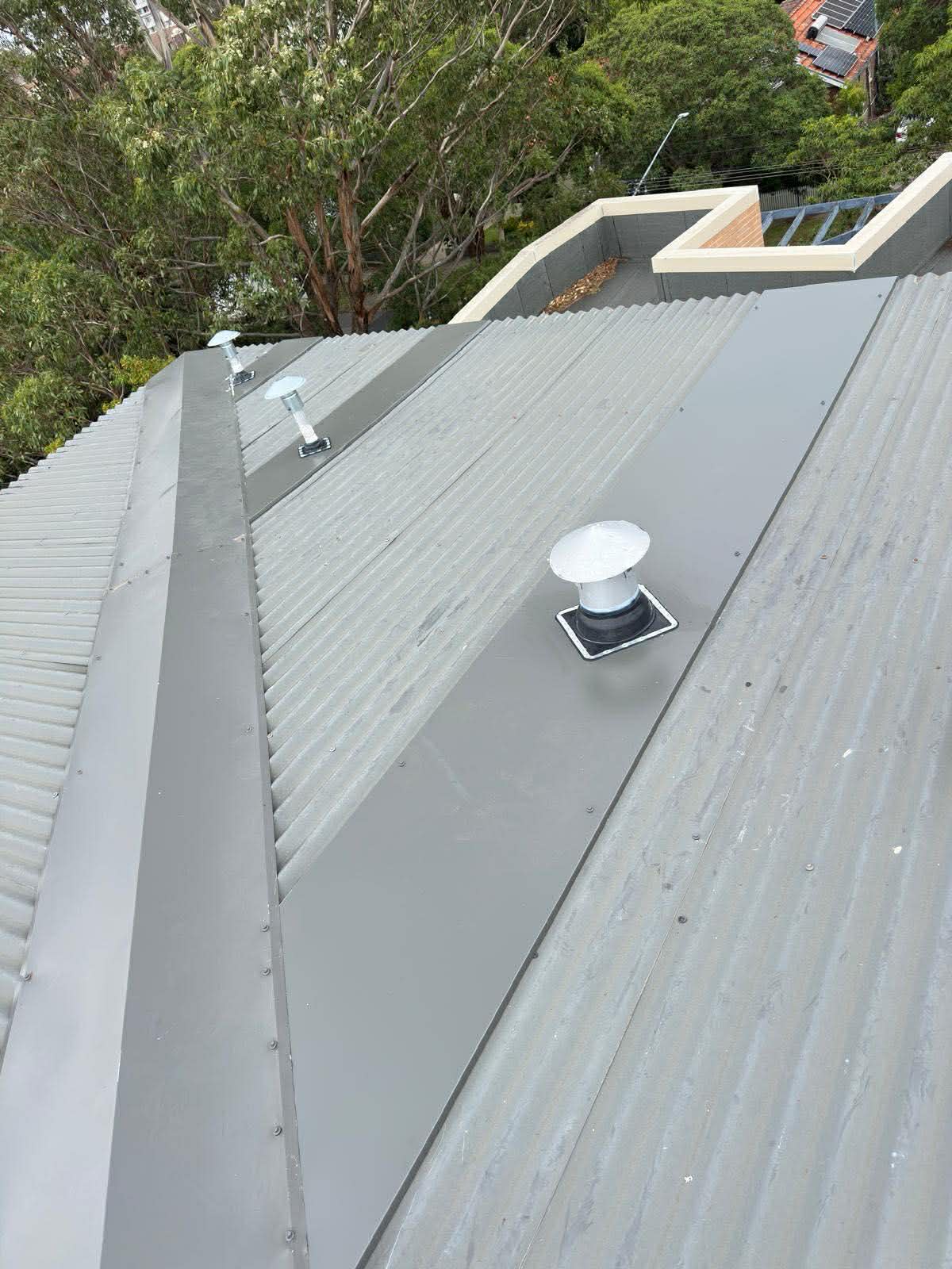 White corrugated metal roof stepped parapet Sydney